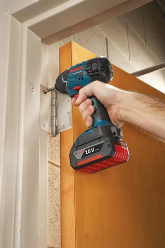 Bosch Lithium-Ion 18V Li-Ion cordless drill being used to install a door hinge.