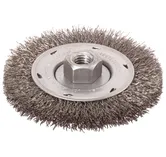 Brosse métallique avec écrou hexagonal central et plaque métallique avec texte visible "WEAR EYE PROTECTION".