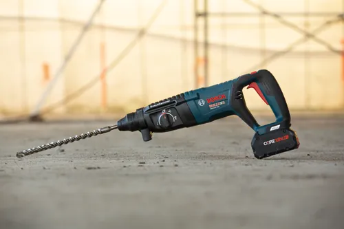 bosch cordless 18v AMPshare CORE18V rotary hammer bulldog sitting on a concrete floor outside