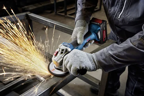 Worker using the Bosch GWX18V-8-2N 18V X-LOCK 4-1/2 In. Angle Grinder for cutting a steel plate.