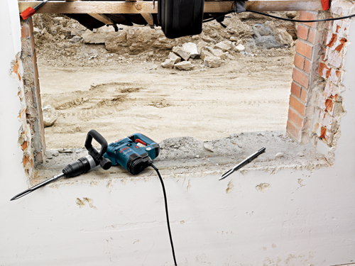 Bosch 11321EVS electric hammer, with brick and dirt in the background.