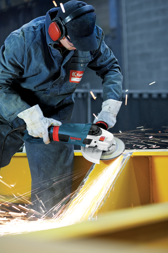 Man in coveralls and protection gear using a Bosch large angle grinder grinding metal.