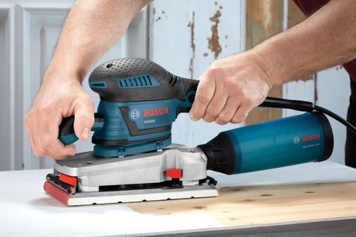 Bosch OS50VC Microfilter System sander being used on a wooden surface.