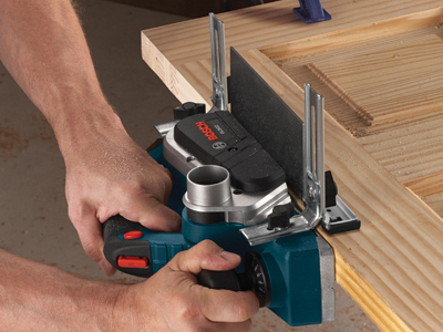 Bosch PL202 electric planer being used on wood, with Bosch logo visible.