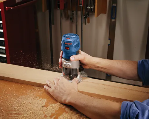 Bosch GKF125CE router being used to cut a piece of wood.