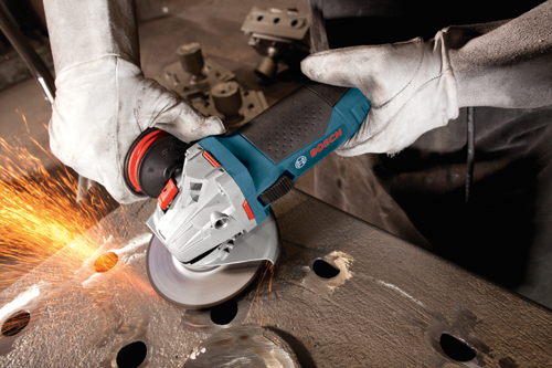 Bosch angle grinder in use, with sparks flying from the contact point.