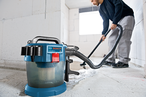 Bosch GAS18V-3 vacuum cleaner, and person vacuuming the floor.