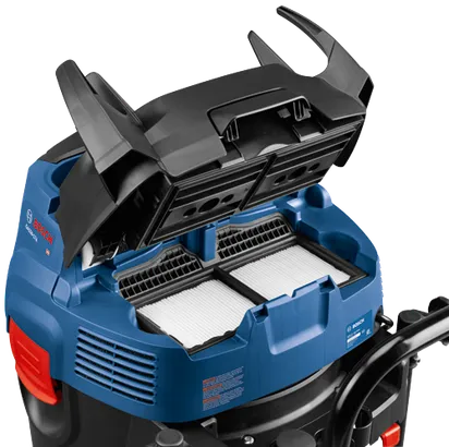 Bosch GAS20-17A dust extractor, blue and black, open top, with filters visible, with warning label.