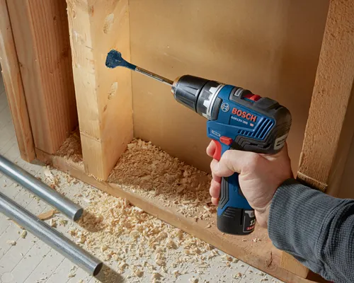 Bosch GSR12V-300 HD drill drilling a hole in wood with Daredevil 801 drill bit.