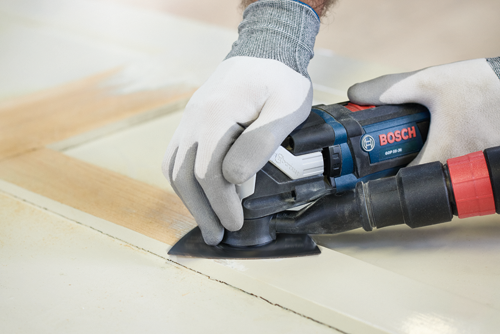 Bosch GOP 55-36 multi-tool being used to sand a door.