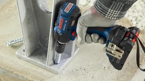 Bosch GDS18V-221 impact driver installing a bolt into a metal structure.
