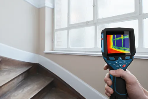 Bosch thermal imaging camera, displaying a window in thermal colors, held by a person.