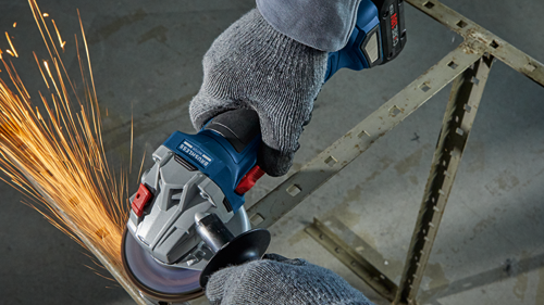 Bosch brushless motor angle grinder cutting metal, sparks visible, person wearing gloves.