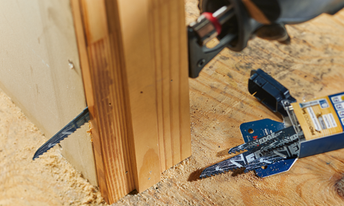 Reciprocating saw blade cutting through wood, with additional blade visible, and "EDGE" printed.