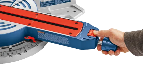 Bosch miter saw with a hand operating a blue handle.