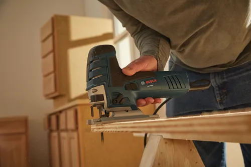 Bosch JS470EB jigsaw being used to cut wood.