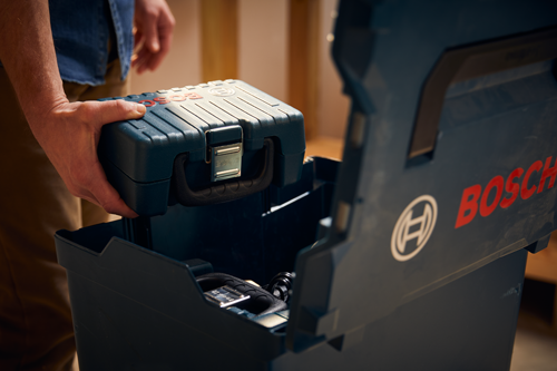 Bosch toolbox held by a person, with a visible "BOSCH" logo.