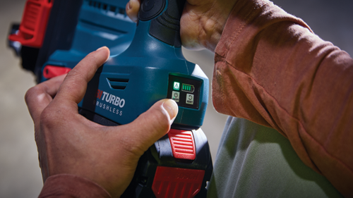 Bosch TURBO BRUSHLESS power tool with on/off, reset, and battery charge indicator illuminated; held by a person.