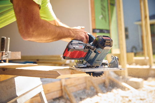 Bosch circular saw cutting wood with a person holding it.