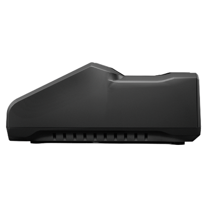 Black rectangular object with a ridge on top and vertical slots at the bottom.