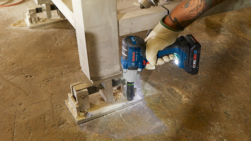 Bosch GDS18V-330C impact wrench being used to secure an anchor to a concrete support.