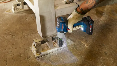 Bosch GDS18V-330C impact wrench being used to secure an anchor to a concrete support.