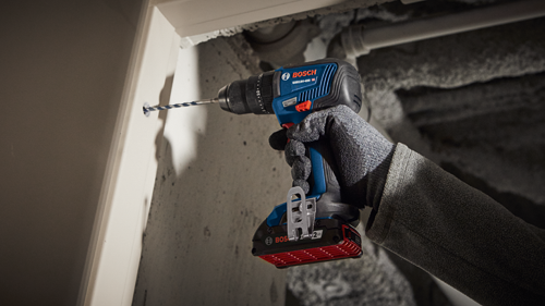 Bosch GSB18V-490 HD cordless drill being used to drill a hole.