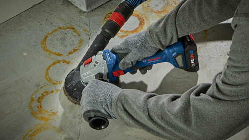 Bosch GWS18V-8 brushless angle grinder with CORE18V battery, being used on concrete.