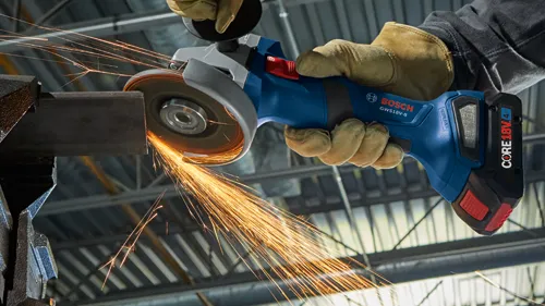 Bosch GWS18V-8 grinder, sparks flying, held by person wearing gloves, working on metal.