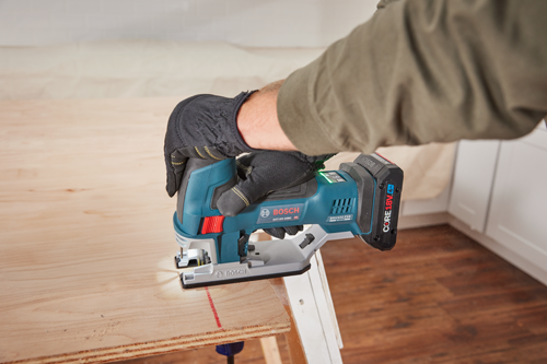 Bosch GST18V-60BC cordless jigsaw being used to cut wood, CORE18V 4Ah battery attached, Brushless Motor.