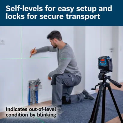 Bosch GLL50-20G level with green laser lines, on a tripod, indicates out-of-level condition by blinking; a person is drawing on a wall.