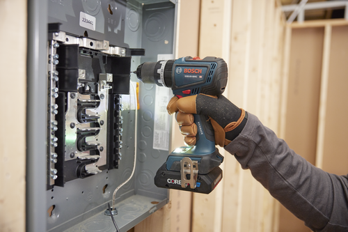 Bosch GSB18V-800C HD cordless drill with CORE battery being used on an electrical panel.