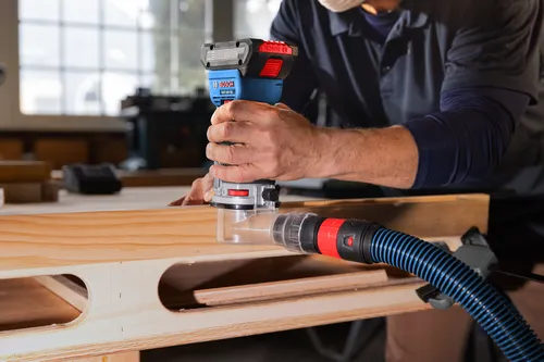 Bosch cordless palm router GKF18V-25 model application image on wood working.