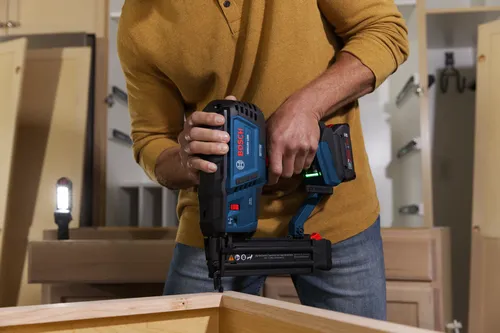 Bosch GNH18V-18M 18V cordless nailer with 18ga Nail Capacity 5/8-2-1/8 in. (15-54 mm) (L) being used by a person.