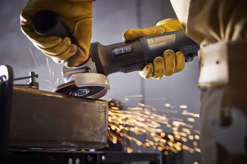 Bosch GWS12-450PBD angle grinder grinding metal, sparks visible.