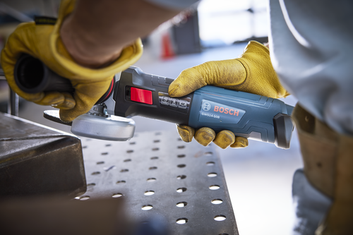 Bosch GWS14-50B angle grinder being used, with safety features visible.
