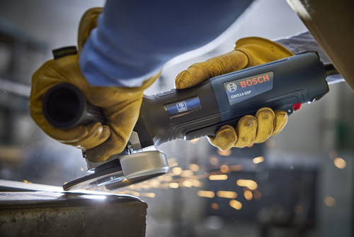 Bosch GWS14-50P angle grinder cutting metal with sparks flying.