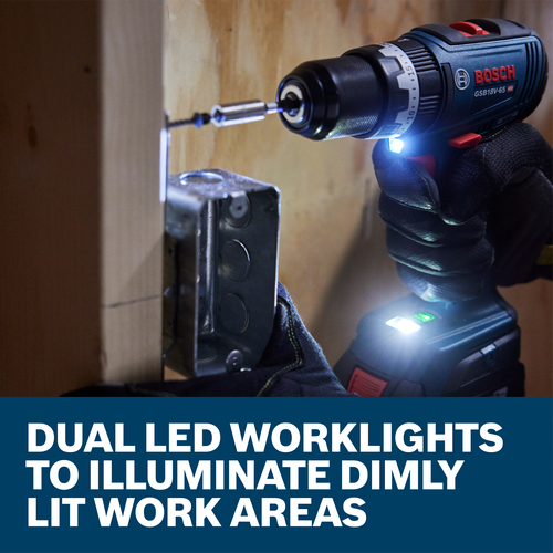 Bosch GSB18V-65 HD cordless drill with dual LED worklights illuminating a dimly lit work area.