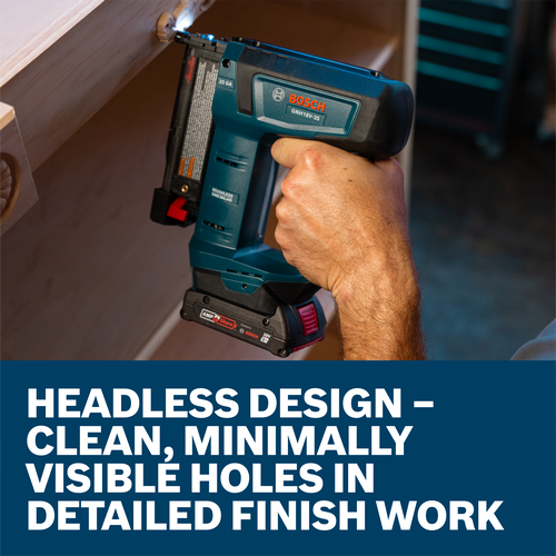 A worker holding a Bosch 18V 23-Gauge Pin Nailer to install shelving.