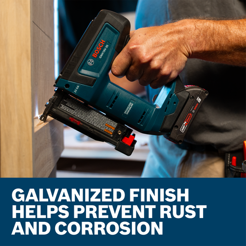 A worker using a Bosch GNH18V-35 23-Gauge Pin Nailer to install wood cabinets.