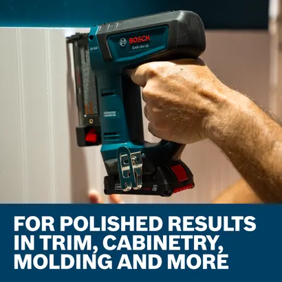 A worker using the Bosch GNH18V-35 23-Gauge Pin Nailer to install shiplap on a wall.