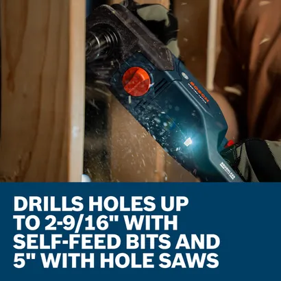 A worker using a Bosch GRD18V-127HX 18V 7/16 In. High Torque Right Angle Drill drilling in a wood stud frame.