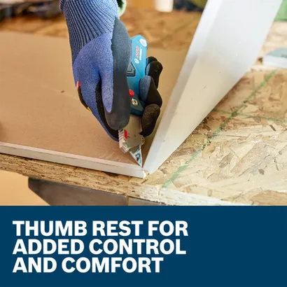 A worker using the Bosch H11-11100-1 folding utilty knife to cut a thin wooden board.