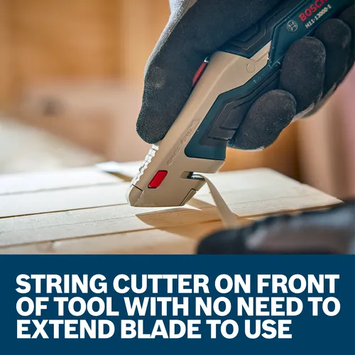 A worker using the Bosch Retractable Utility Knife H11-13000-1 to cut a wood material.