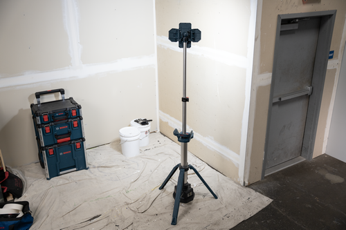 The Bosch GLT18V-5000N 18V Tower Light positioned in the center of a room undergoing renovation for lighting purposes.