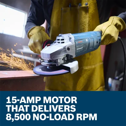 The worker using the Bosch GWS22-180J 7 In. Large Angle Grinder to grind the edge of a piece of metal in a work shop.