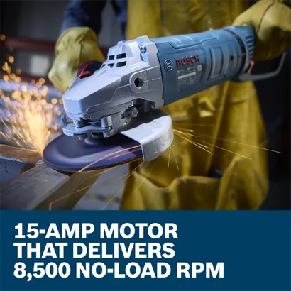 The worker using the Bosch GWS25-180PR 7 In. Large Angle Grinder to grind the edge of a piece of metal in a work shop.