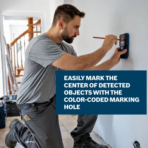 The working using the Bosch GMS120-27 Wall Scanner on the interior wall of a house.