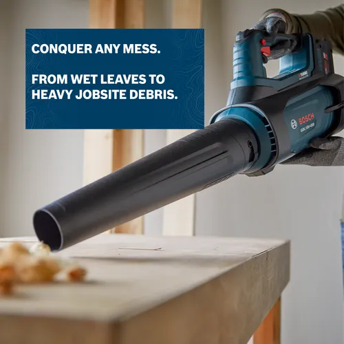 Image of worker blowing sawdust with the Bosch GBL18V-450N PROFACTOR™ 18V Blower on a workshop.