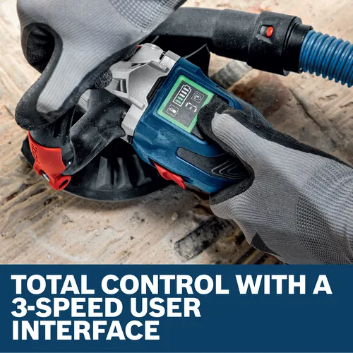 Image of worker using the Bosch GBR18V-15SN18X 5 In. 18V Concrete Surface Grinder on the concrete floor.